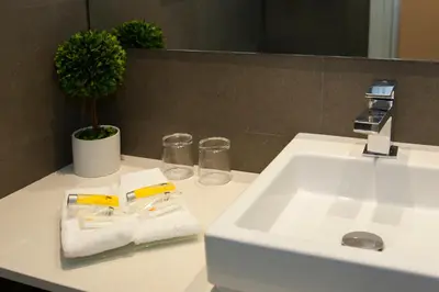 a bathroom sink with a towel and two glasses at Hostal Goya in Barcelona