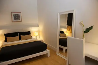 a bedroom with a bed and a mirror at Hostal Goya in Barcelona