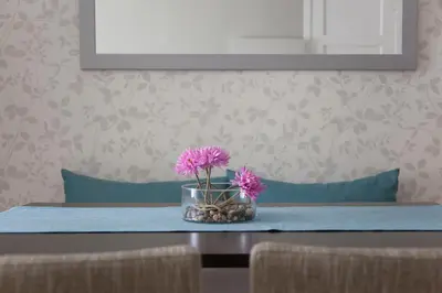 a table with a vase with pink flowers on it at Hostal Goya in Barcelona
