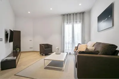 a living room with a couch and a coffee table at Fisa Rentals Gran Via Apartments in Barcelona