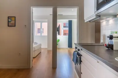 a kitchen with white cabinets and a counter top at Vibe Apartments by Olala Homes in Hospitalet de Llobregat