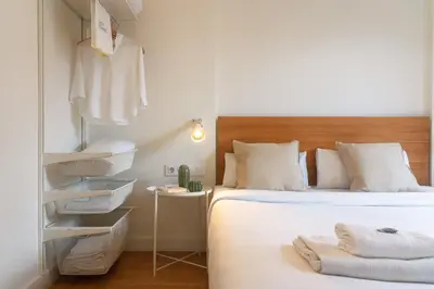 a bedroom with a bed with towels on it at Vibe Apartments by Olala Homes in Hospitalet de Llobregat