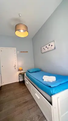 a bedroom with a blue bed in a room at Apartamento Sants in Barcelona