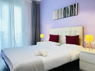 a bedroom with two beds with red pillows at Apartamento Sants in Barcelona