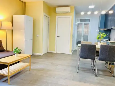 a kitchen and dining room with a table and a refrigerator at Apartamento Sants in Barcelona
