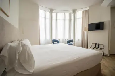 a bedroom with a large white bed with windows at Storni Barcelona by Forget me not in Barcelona