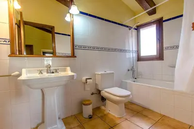 a bathroom with a sink and a toilet and a mirror at Catalunya Casas Country Chateau for 22 persons - close to Sitges! in Les Masuques