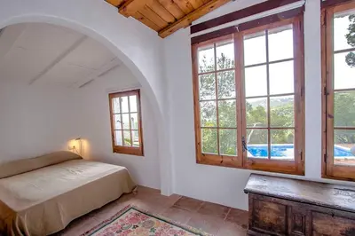 a bedroom with a bed and two windows at Catalunya Casas Majestic Villa and Views , 30km to Barcelona in Corbera de Llobregat