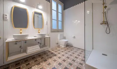 a bathroom with two sinks and a shower at You Stylish City Center Apartments in Barcelona