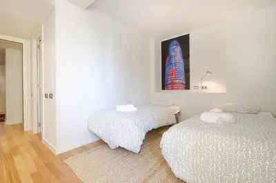 a bedroom with two beds and a picture on the wall at You Stylish City Center Apartments in Barcelona