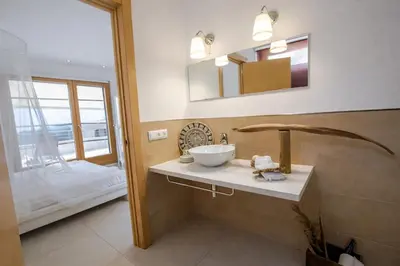 a bathroom with a sink and a mirror at Catalunya Casas Modern Magnificence , only a few km to the beach! in Sant Cebrià de Vallalta