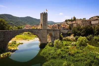 an old bridge over a river in a town at Catalunya Casas Modern Magnificence , only a few km to the beach! in Sant Cebrià de Vallalta