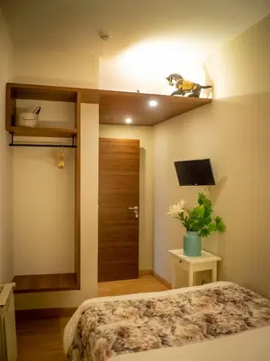 a bedroom with a bed and a wooden door at Pension Ciudadela in Barcelona