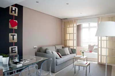 a kitchen with wooden cabinets and stainless steel appliances at Eric Vökel Boutique Apartments - Gran Vía Suites in Barcelona