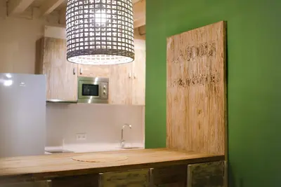 a kitchen with a counter and aendant light at La Bodega Suites in Hospitalet de Llobregat