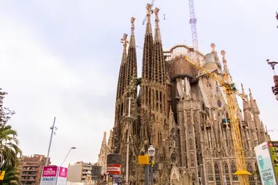 a large cathedral with a building under construction at Charm Apartment Sagrada Familia in Barcelona