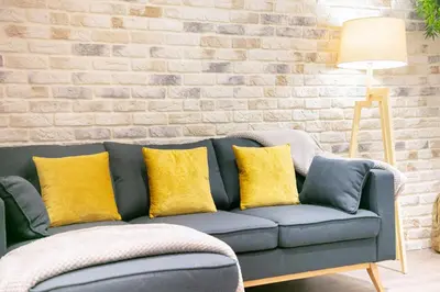 a living room with a couch with yellow pillows at KeyFamily Lovely Villa in Barcelona