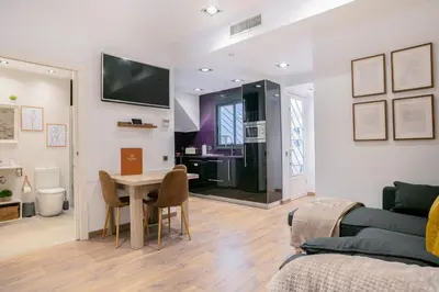 a living room with a table and a couch at KeyFamily Lovely Villa in Barcelona