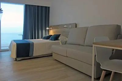 a living room with a bed and a couch at Rocatel in Canet de Mar