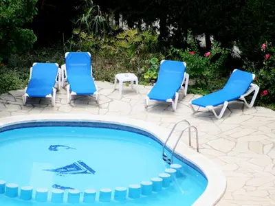 a group of chairs and a swimming pool at Rocatel in Canet de Mar