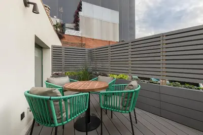 a patio with a table and chairs on a balcony at Be Mate Paseo de Gracia in Barcelona