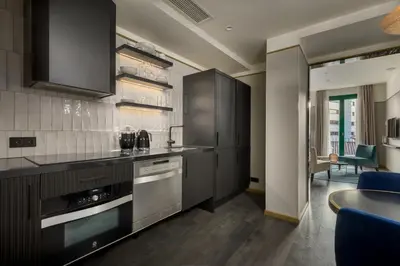 a kitchen with black cabinets and a counter top at Be Mate Paseo de Gracia in Barcelona