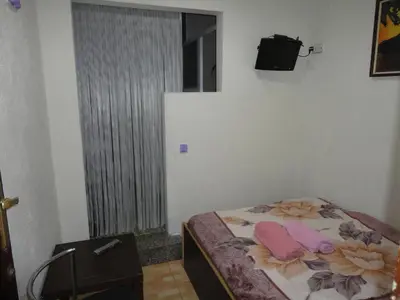 a bedroom with a bed with two pink pillows on it at Central Station Hostel Barcelona in Barcelona