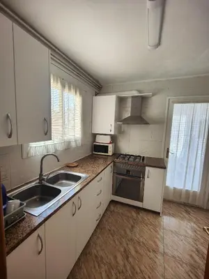 a kitchen with white cabinets and a sink at Sitges Malvasia · Paz en el Corazón de Sitges in Sitges