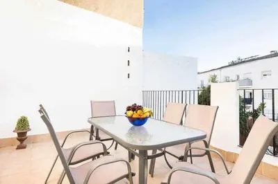 a table with chairs and a bowl of fruit on a balcony at Sitges Malvasia · Paz en el Corazón de Sitges in Sitges