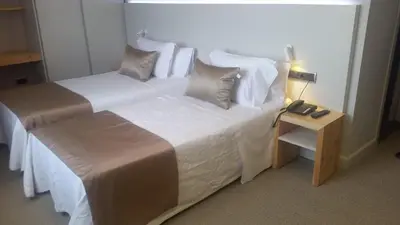 a bedroom with a large bed with white sheets and pillows at Hotel Restaurant Sol i Vi in Lavern