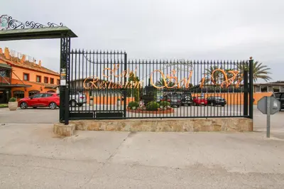 a black gate with a sign for a circus at Hotel Restaurant Sol i Vi in Lavern