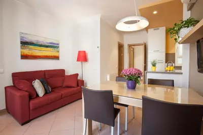 a living room with a red couch and a table at BCNGOTIC 42 in Barcelona