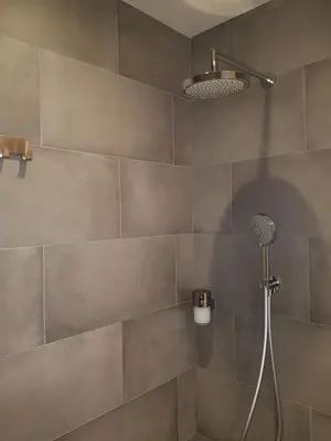 a shower with a shower head in a bathroom at Gava Ocean View in Gavà