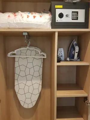 a shelf in a room with a bed and a microwave at Gava Ocean View in Gavà
