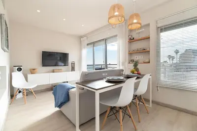 a kitchen and dining room with a table and chairs at Gava Ocean View in Gavà