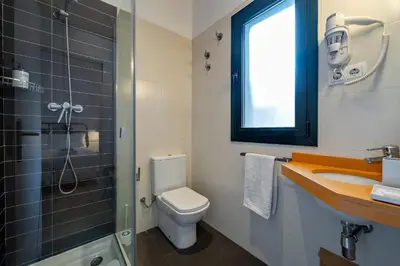 a bathroom with a toilet and a sink and a shower at Verdi Habitat Apartments in Barcelona