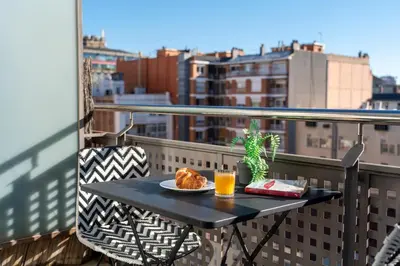 a table with a plate of food on a balcony at TSA Sepulveda in Barcelona