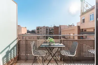 a table and chairs on a balcony with a view at TSA Sepulveda in Barcelona