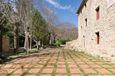 a cobblestone street in front of a stone building at Sant Marçal del Montseny in Montseny