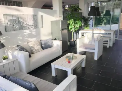 a living room with a couch and a table at Beach House in Castelldefels