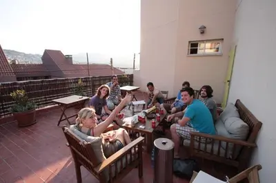 a group of people sitting around a table on a patio at Mellow Barcelona in Barcelona