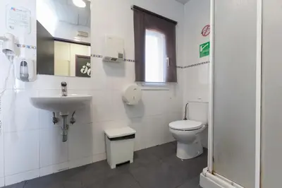 a bathroom with a toilet and a sink at Mellow Barcelona in Barcelona