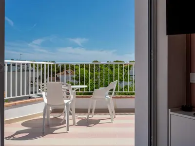 a balcony with a table and chairs on a balcony at Apartamentos Sunway Atlanta in Sitges