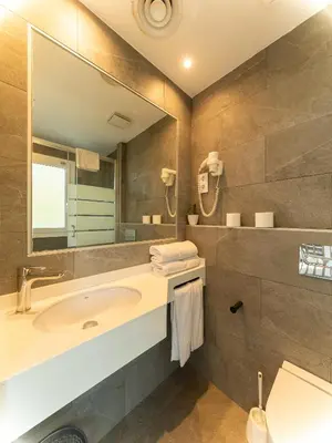 a bathroom with a sink and a mirror at Apartamentos Sunway Apollo in Sitges