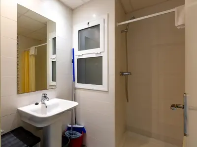 a bathroom with a sink and a shower and a mirror at Apartamentos Sunway San Jorge in Sitges