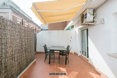 a patio with a table and chairs in a building at Alcam Rogent in Barcelona