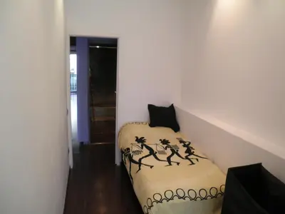 a small room with a bed and a staircase at Bacrou apartment, design loft near the sea in Barcelona