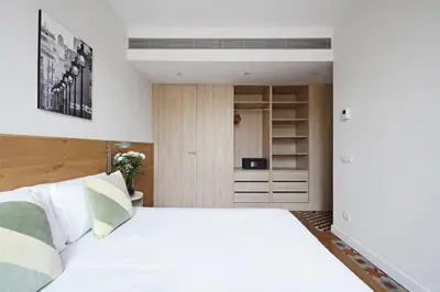 a bedroom with a large white bed and a closet at Ola Living Boqueria in Barcelona
