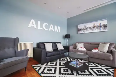 a living room with two couches and a sign on the wall at Alcam Plaza Cataluña in Barcelona