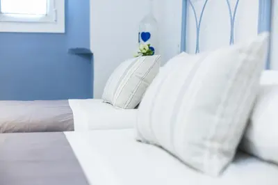 a bedroom with a bed with pillows on it at Vilasarmarlux II in Vilassar de Mar